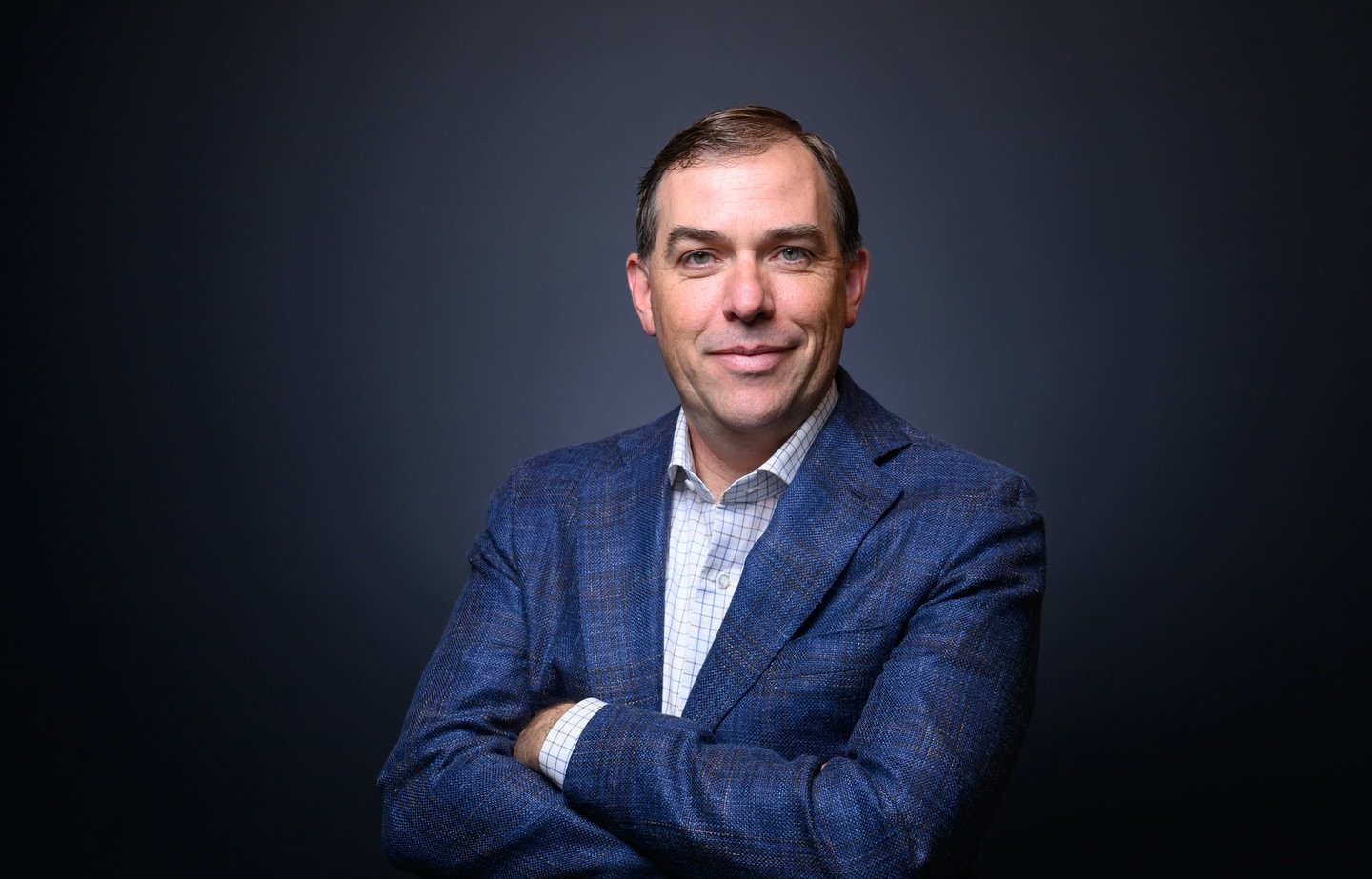 Amazon Web Services (AWS) CEO Matt Garman stands for a portrait at Amazon's headquarters in Seattle, Washington. Photo by Josh Edelson for AWS.
